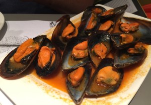 Plate of mussels in a olive oil and tomato sauce